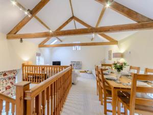 a dining room with a long wooden table and chairs at Westwood Barn in Brough Sowerby +16 photos