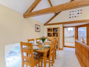 a dining room with a wooden table and chairs at Westwood Barn in Brough Sowerby