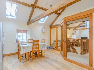 a kitchen and dining room with a table and chairs at Westwood Barn in Brough Sowerby