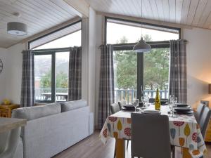a dining room with a table and a large window at Cruachan in Etteridge