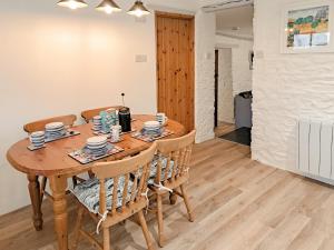 a dining room with a wooden table and chairs at Appleloft in Crackington Haven