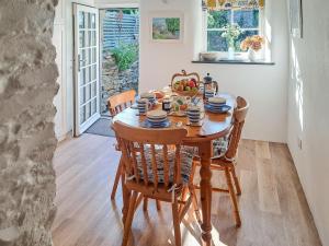 a dining room table with a bowl of fruit on it at Appleloft in Crackington Haven
