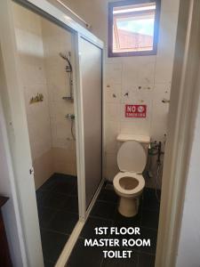 a bathroom with a first floor master room toilet at B&C Homestay in Miri