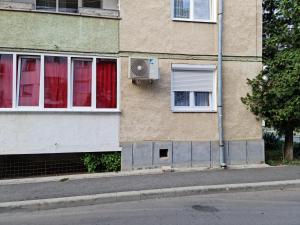 a building with a fan on the side of it at White Stone in Sibiu