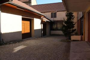 an empty driveway next to a building with a garage at Touring Hotel in Bellegarde-sur-Valserine