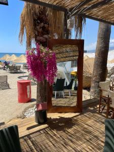 a mirror and a bouquet of flowers on a beach at Grand Cennet Beach Hotel in Akcay