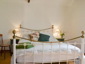 a bedroom with a white bed with a canopy at Cowslip Cottage Ukc1898 in Dogdyke