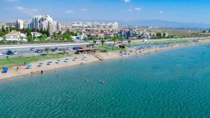 an aerial view of a beach with people and umbrellas at Grand Sapphire Hotel, Casino & Spa Holiday Deluxe Residential Home in Iskele