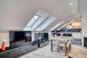 a dining room with a table and a tv at CitySpace Košická in Nivy