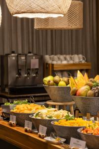 a buffet with bowls of different types of food at Blue Tree Premium Paulista in Sao Paulo