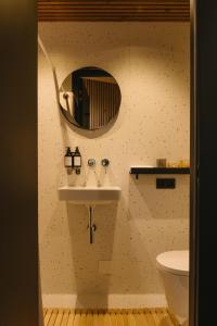 a bathroom with a sink and a mirror on the wall at Blackview cabin in Kulautuva