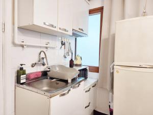 una cocina con fregadero y refrigerador en Exit 4 of Hongik University, en Samgong-ni 1 foto más