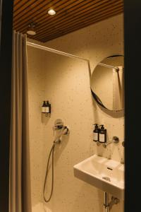 a bathroom with a shower and a sink at Blackview cabin in Kulautuva