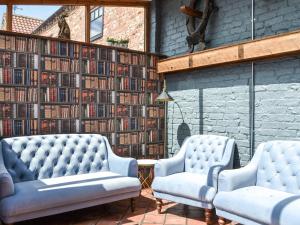 two chairs in front of a wall of books at The Old Stables in Tickton