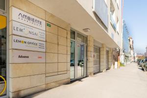 a building with signs on the side of a street at Business & Family Ambiente Apartments in Bratislava