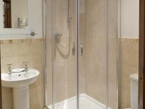 a bathroom with a shower and a sink at Cider Barn in Poundstock