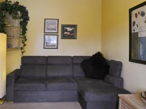 a living room with a gray couch in a room at High Moor Cottage in Dufton