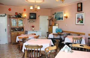 a restaurant with tables and chairs in a room at Apartments by the sea Barbat, Rab - 4993 in Barbat na Rabu