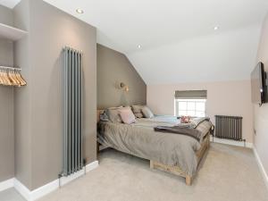 a bedroom with a large bed in a room at Ivy Cottage in Beck Hole +18 photos