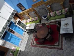 an overhead view of a living room with chairs and tables at Riad Sevilla in Rabat
