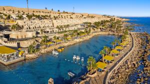 an aerial view of a beach with boats in the water at Pickalbatros Citadel Resort Sahl Hasheesh in Hurghada