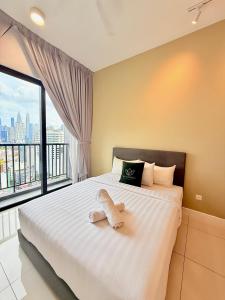 a bedroom with a large bed with a large window at Chambers Suites Mrk in Kuala Lumpur