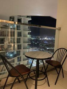 a table and two chairs in front of a window at Yang Apec Mandala Home in Phước Hậu