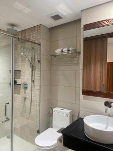 a bathroom with a shower and a toilet and a sink at Yang Apec Mandala Home in Phước Hậu