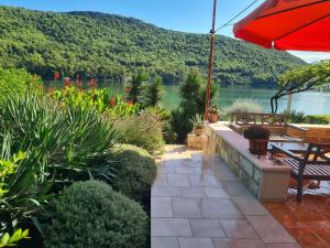 a patio with a view of the water and mountains at Apartments by the sea Broce, Peljesac - 13182 in Ston