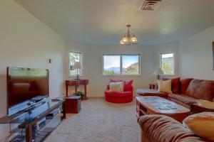 a living room with a couch and a flat screen tv at Amber Sunset in Mosier
