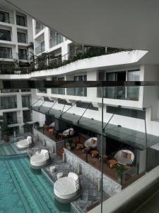 a building with a swimming pool with chairs and a swimming pool at Yang Apec Mandala Home in Phước Hậu