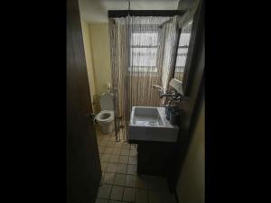 a bathroom with a sink and a toilet at Pipina's Beach Apartment in Fanari +14 photos