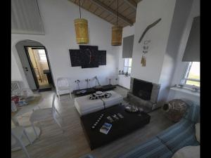 a living room with a couch and a fireplace at Pipina's Beach Apartment in Fanari