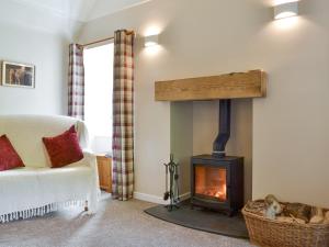 a living room with a wood burning stove at Eagles Gate Lodge in Banff