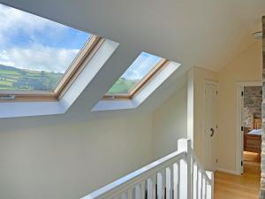 a room with two skylights in the ceiling at Stable Barn - Hw7591 in Bettws-yn-Rhôs +9 photos