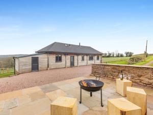 a fire pit on a patio in front of a building at 2 Bed in Collington 91816 in Edwin Loach