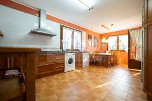 a kitchen with a washer and dryer in it at Casa Sildavia By Silastur in La Riera