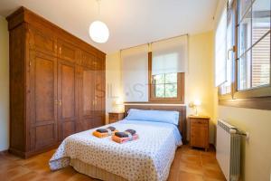 a bedroom with a bed and a large window at Casa Sildavia By Silastur in La Riera
