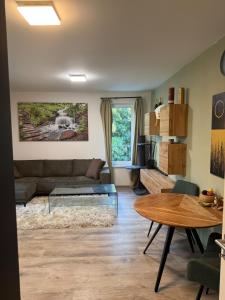 a living room with a couch and a table at Modern Apartment in a Leafy Town Close to Prague 