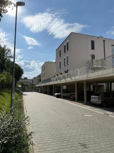 an empty street with a building and a street light at Modern Apartment in a Leafy Town Close to Prague  +14 photos