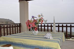 a vase filled with flowers sitting on a table at Villa Agalianos in Kerames +23 photos