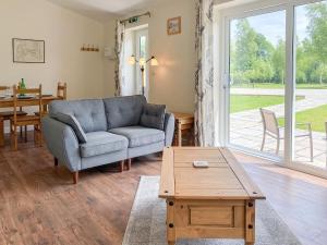 a living room with a couch and a table at Deer Cottage 1 Uk39330 in Biddenden +16 photos