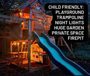 a child friendly playground playground approximate night lights huge garden and private space fire pit at CABIN in hosts huge garden CHILD FRIENDLY with Hens Kittens firepit Marshmallows in Charing