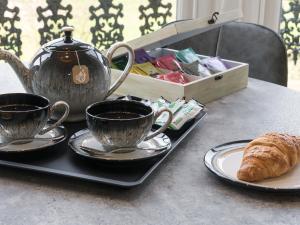 a table with two cups of coffee and a croissant at The Haven in Scarborough +18 photos