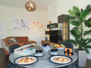 a table with plates of food on it in a living room at The Haven in Scarborough