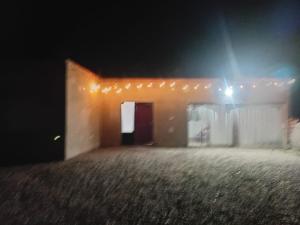 a small house at night with a light at Hospedaje TAWA WASI in Huacalera