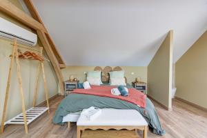a bedroom with a large bed in a attic at L'atelier de Théo - Jacuzzi Privé in Chaourse-en-Thiérache