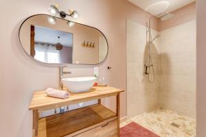 a bathroom with a sink and a mirror at L'atelier de Théo - Jacuzzi Privé in Chaourse-en-Thiérache +18 photos