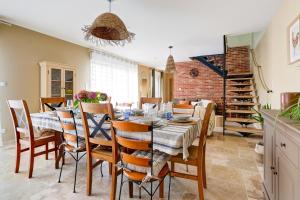 a dining room with a table and chairs at L'atelier de Théo - Jacuzzi Privé in Chaourse-en-Thiérache