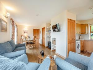 a living room with two blue couches and a table at Cruinn in Taynish
